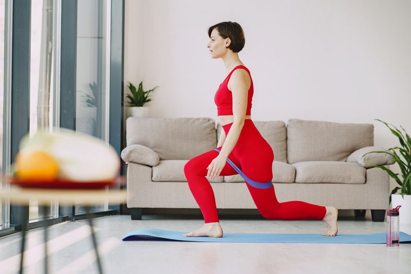 A woman stretching on a mat in her living room